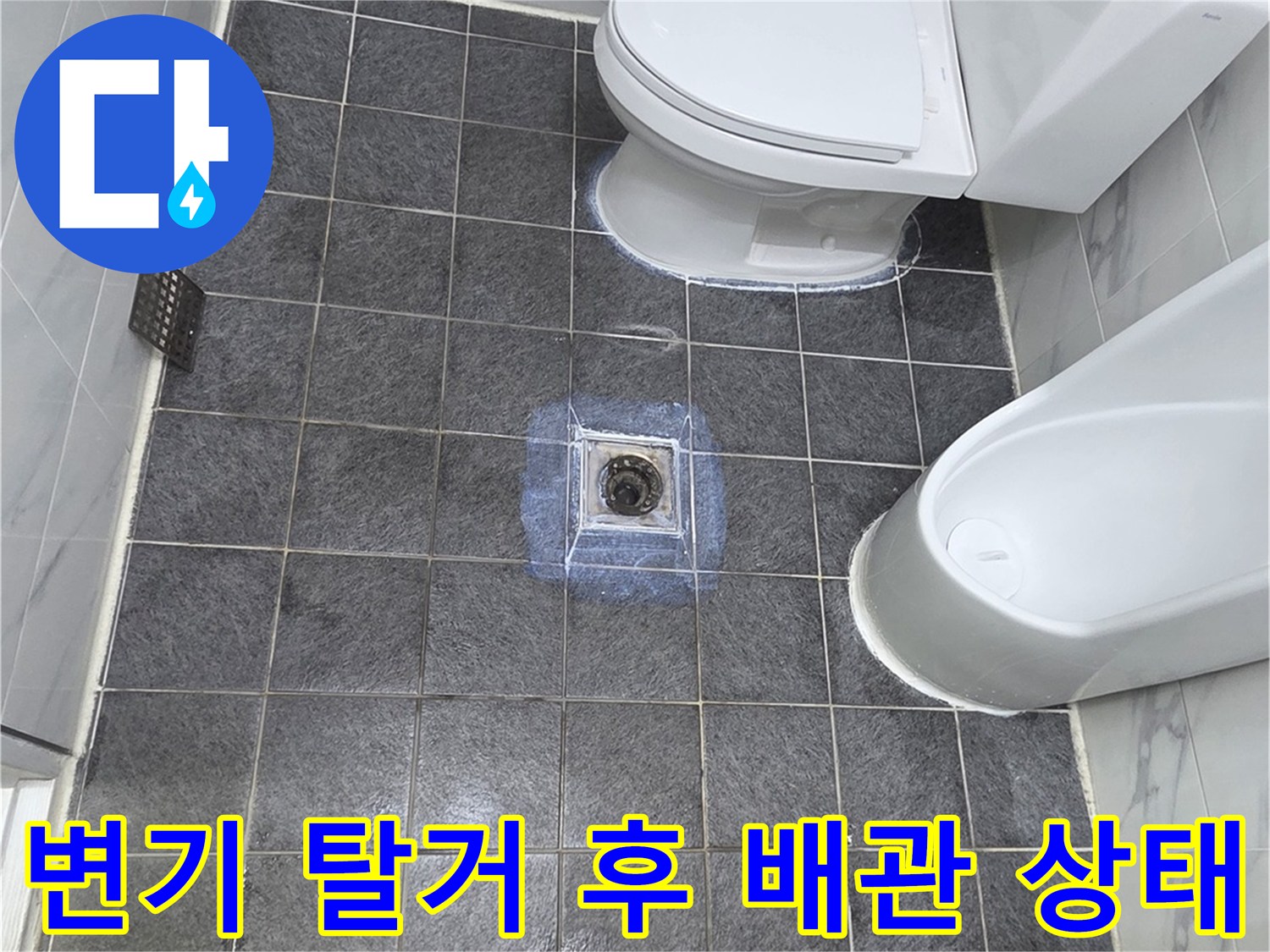 양변기를 제거한 후 드러난 오수 배관과 타일 바닥 모습입니다.