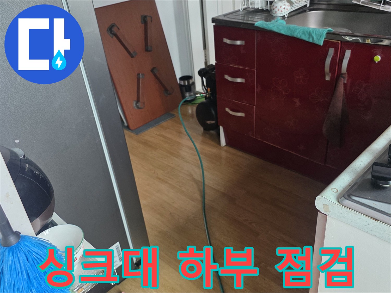 싱크대 아래 배관과 바닥 타일 사이의 상태를 촬영한 사진입니다.