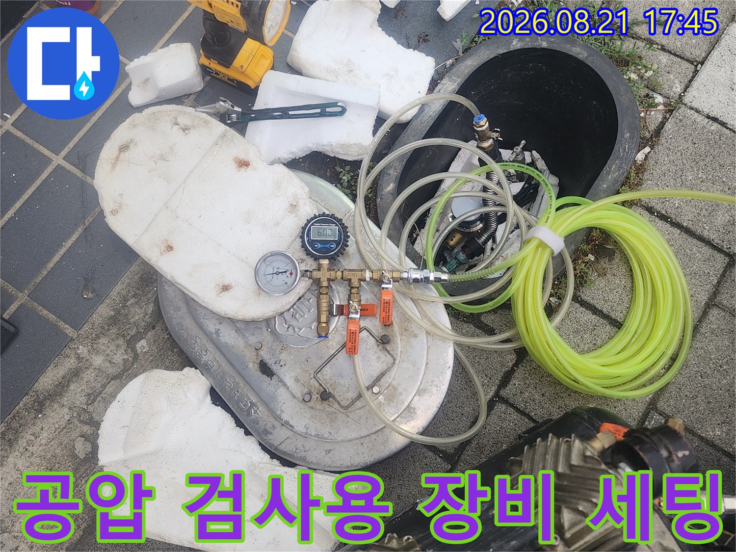 배관 압력 테스트를 위해 현장에 준비된 호스와 게이지 도구