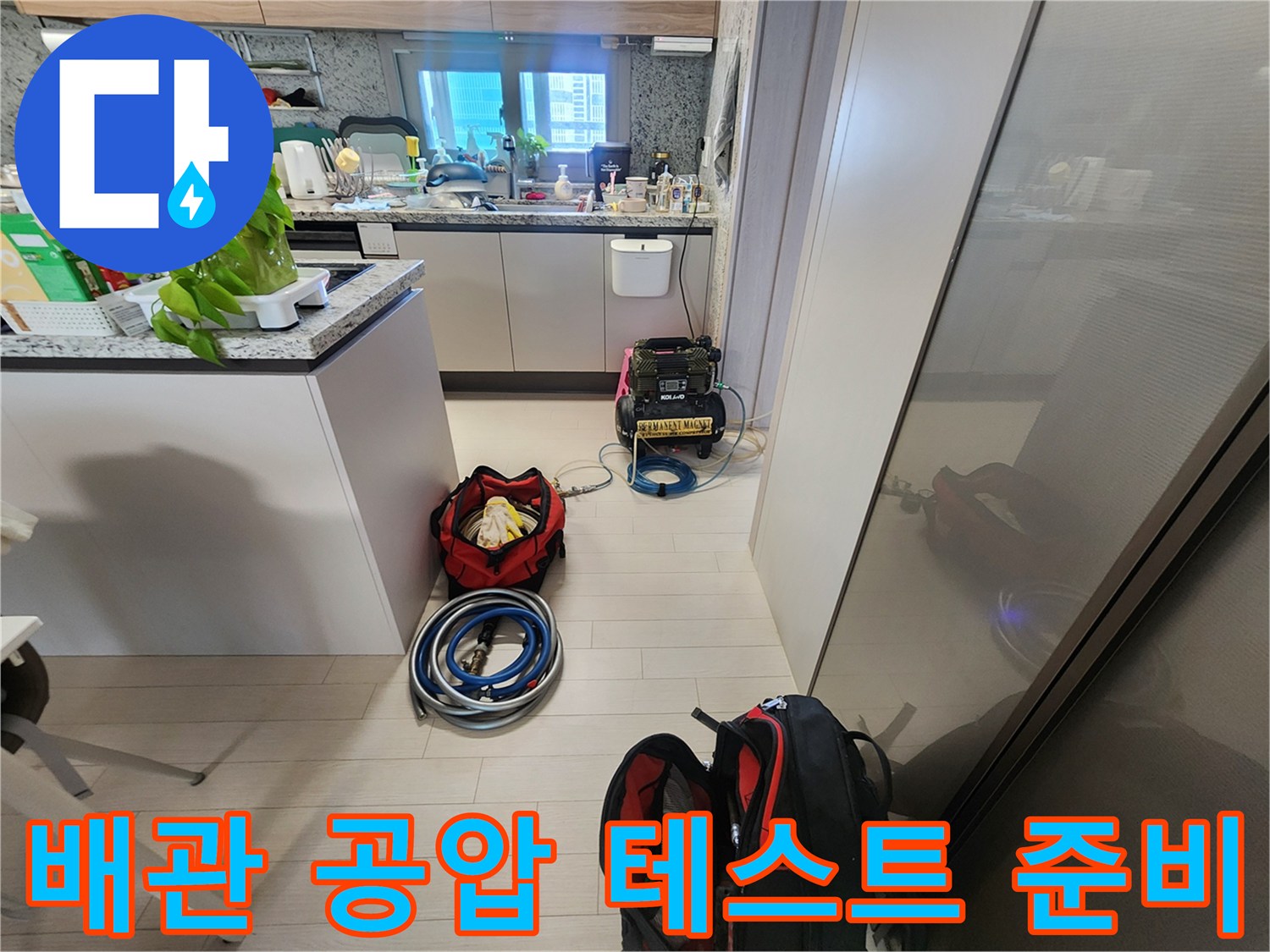 싱크대 하부 공간에 설치된 배관 압력 측정 장치와 연결 호스