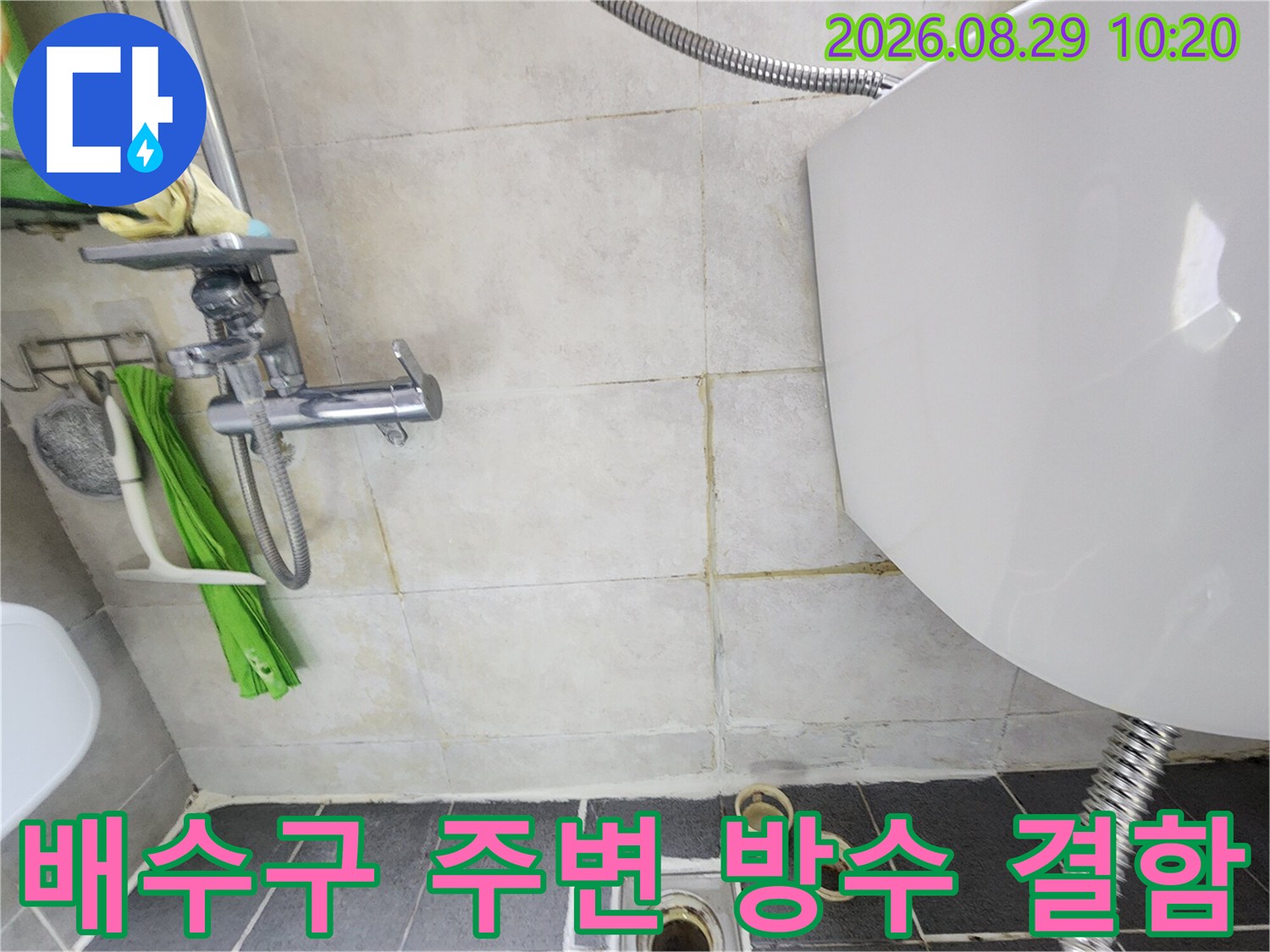 화장실 배수구 유가와 타일 사이의 틈새를 근접 촬영한 사진입니다.