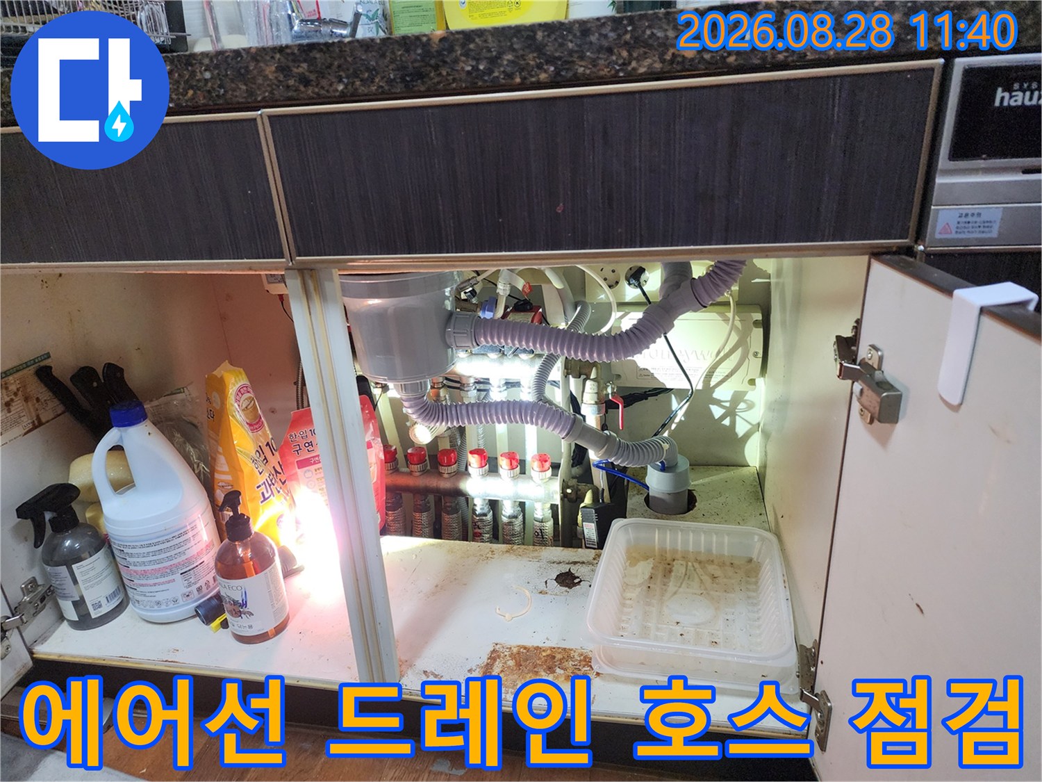 주방 싱크대 하부 배수 호스의 연결 부위와 배관 상태 상세 보기