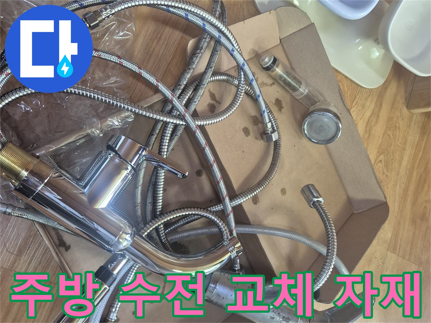박스 안에 담긴 새 싱크대 수전과 연결 호스 부품들