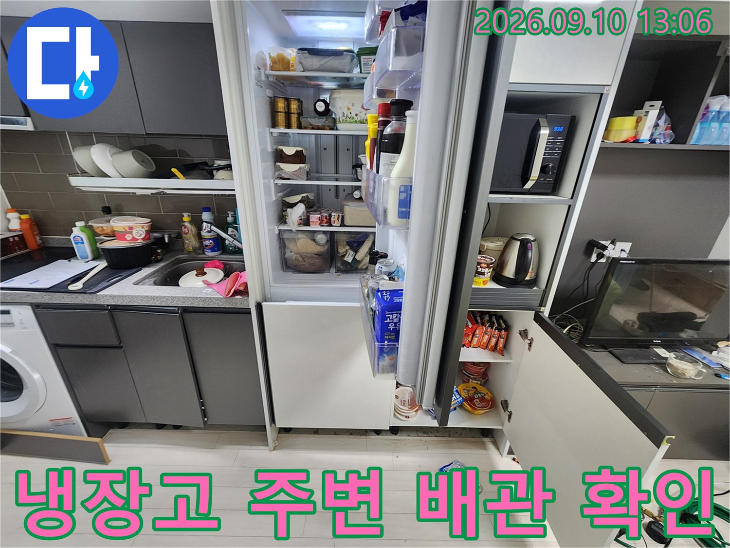 주방 냉장고 옆 싱크대 하단 배관 연결 부위 점검 상황