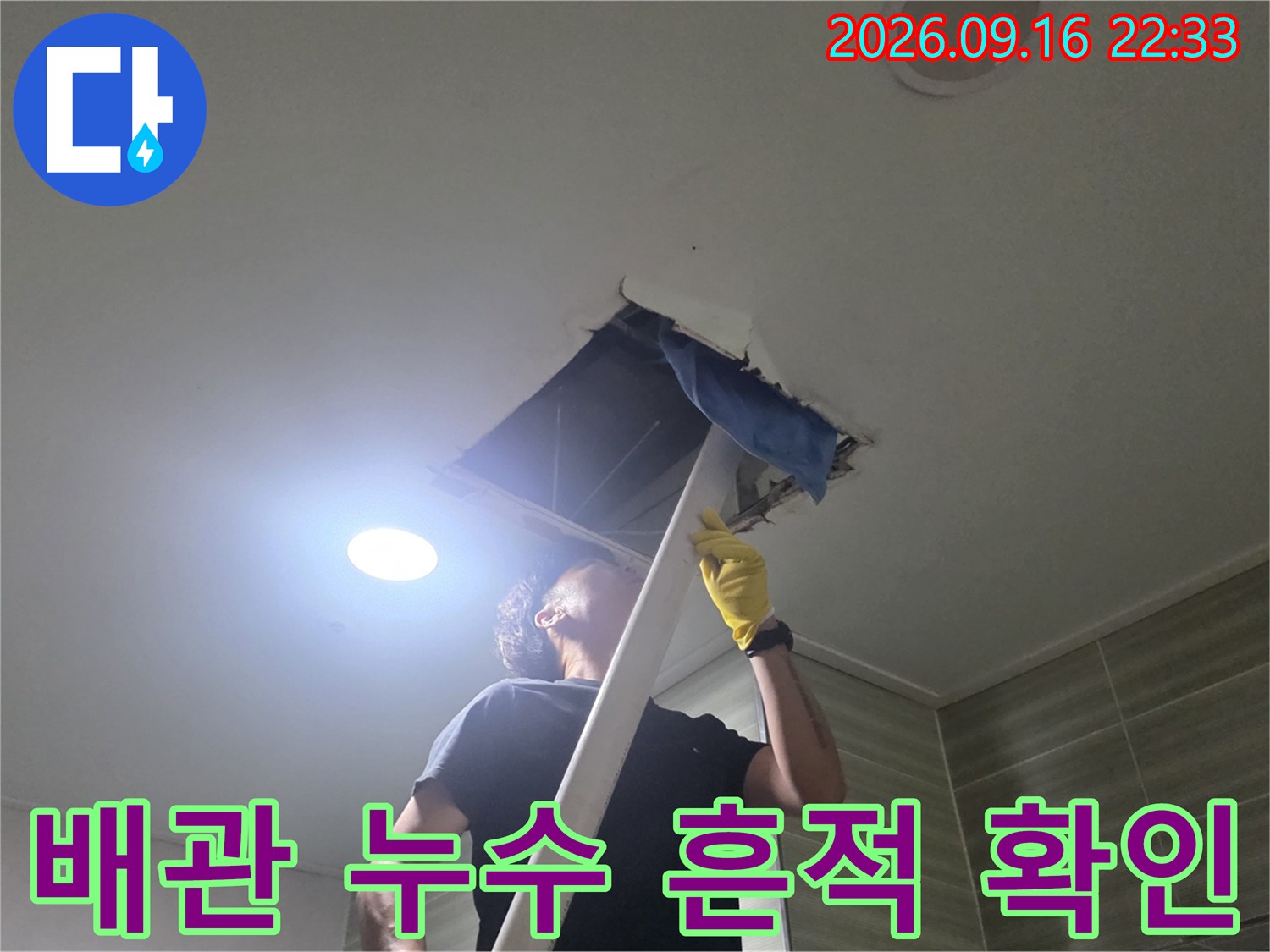 점검구 내부의 배관과 습기 상태를 점검하는 모습